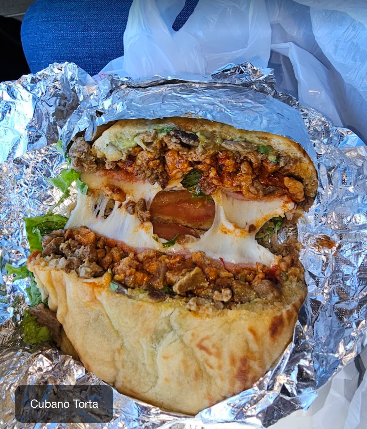 Cubano torta stacked with meats and melted cheese