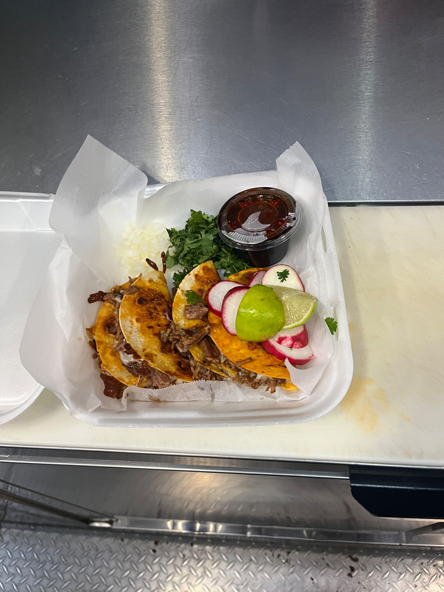 Order of birria tacos in a takeout tray